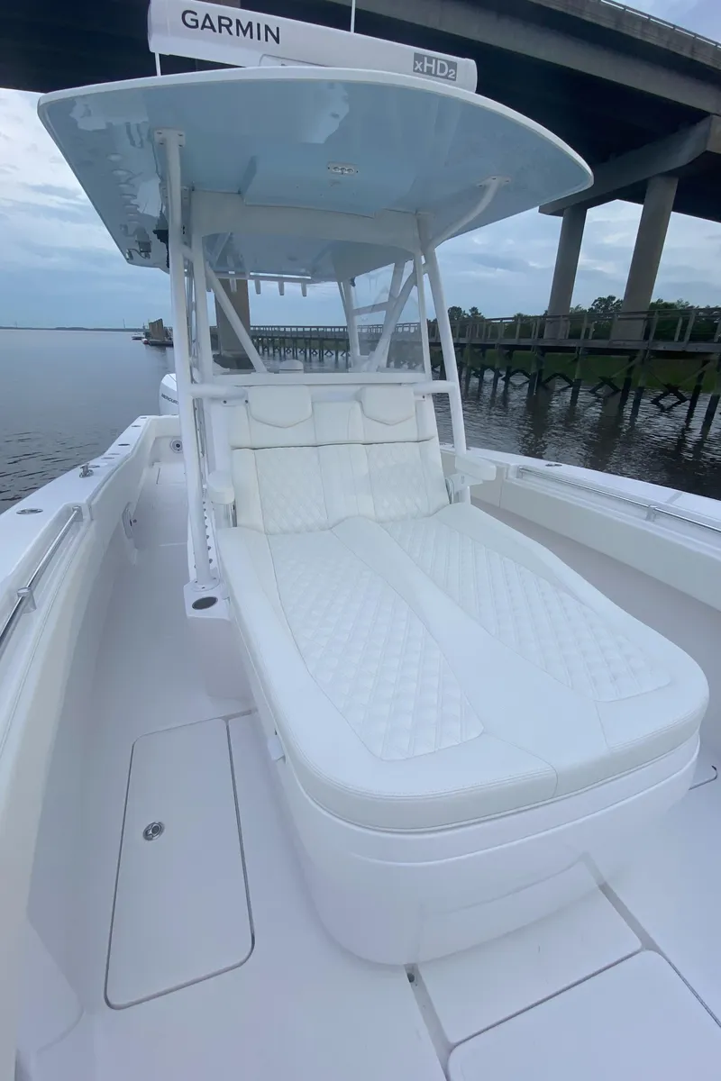 Slide: The Image of 2021 Invincible 36 Open Fisherman boat with cushioned seating, under a bridge. - 8