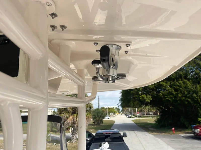 Slide: The Image of 2025 Sea Chaser 30 HFC CC boat detail, featuring a mounted rod holder on the T-top. - 11