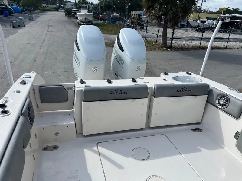 Slide: The Image of 2025 Sea Chaser 30 HFC CC boat with dual outboard engines, docked on a sunny day. - 12