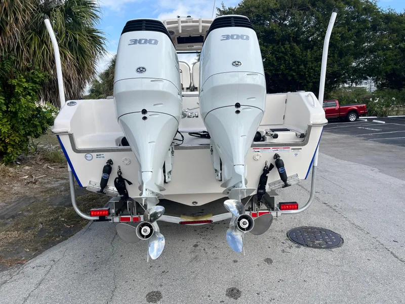 Slide: The Image of 2025 Sea Chaser 30 HFC CC boat with dual outboard engines, rear view. - 14
