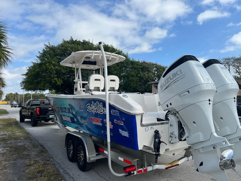 Slide: The Image of 2025 Sea Chaser 30 HFC CC boat on trailer with dual Suzuki engines. - 16