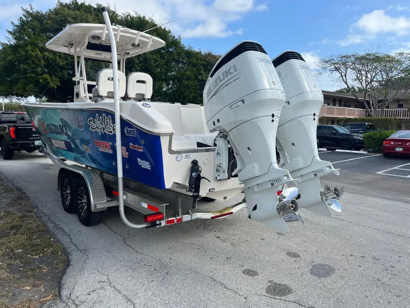 Slide: The Image of 2025 Sea Chaser 30 HFC CC boat with dual Suzuki outboard motors on a trailer. - 17