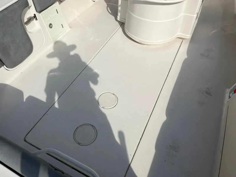 Slide: The Image of 2025 Sea Chaser 30 HFC CC boat deck with storage compartments and shadow. - 7