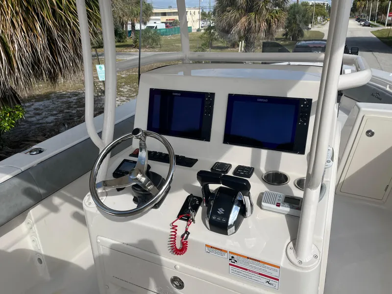 Slide: The Image of 2025 Sea Chaser 30 HFC CC boat console with dual screens and steering wheel. - 8