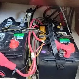 Slide: The Image of Batteries with red and black cables in a 1984 Catalina Sloop sailboat. - 13