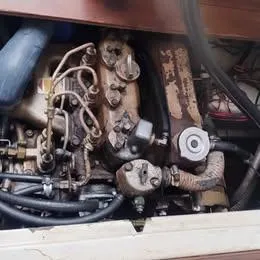 Slide: The Image of 1984 Catalina Sloop engine compartment with visible mechanical components and wiring. - 16