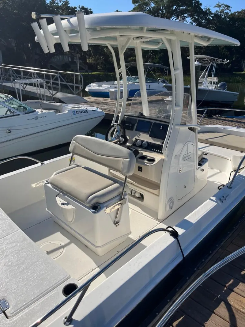 Slide: The Image of 2019 Boston Whaler 210 Dauntless boat with center console and seating, docked at marina. - 4