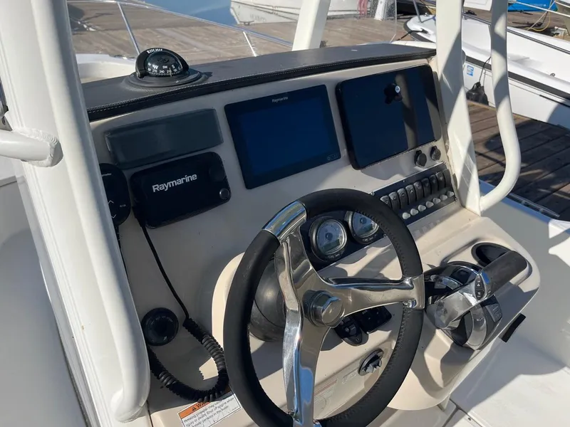 Slide: The Image of 2019 Boston Whaler 210 Dauntless helm with Raymarine electronics and steering wheel. - 7