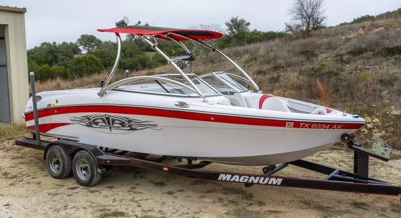 The Image of 2007 Correct Craft Air Nautique 226 LE boat on trailer, red and white design. - 0