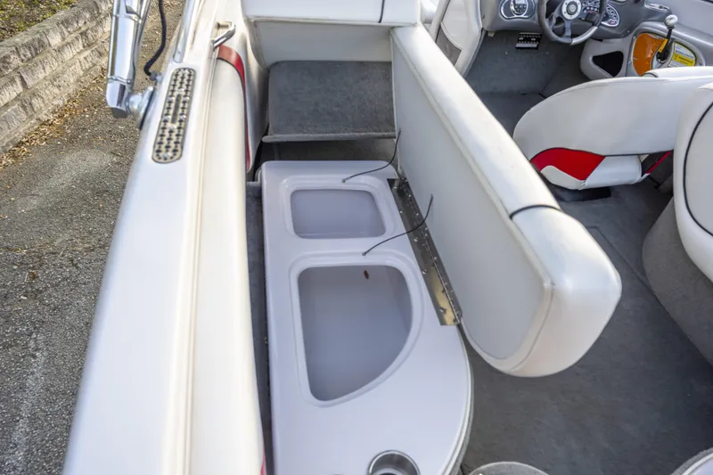 Slide: The Image of 2007 Correct Craft Air Nautique 226 LE interior with storage compartments and seating. - 13