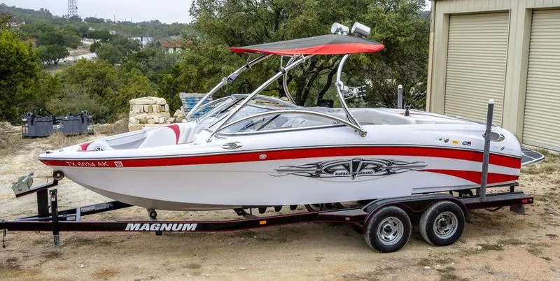 Slide: The Image of 2007 Correct Craft Air Nautique 226 LE boat on trailer, red and white design. - 3