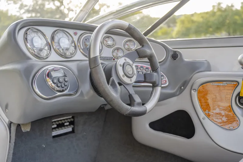 Slide: The Image of 2007 Correct Craft Air Nautique 226 LE dashboard with steering wheel and instrument panel. - 6