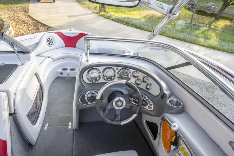 Slide: The Image of 2007 Correct Craft Air Nautique 226 LE boat interior with steering wheel and dashboard controls. - 7