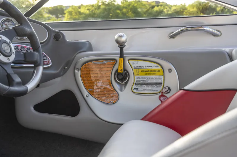 Slide: The Image of Interior of 2007 Correct Craft Air Nautique 226 LE boat, featuring steering wheel and control panel. - 8