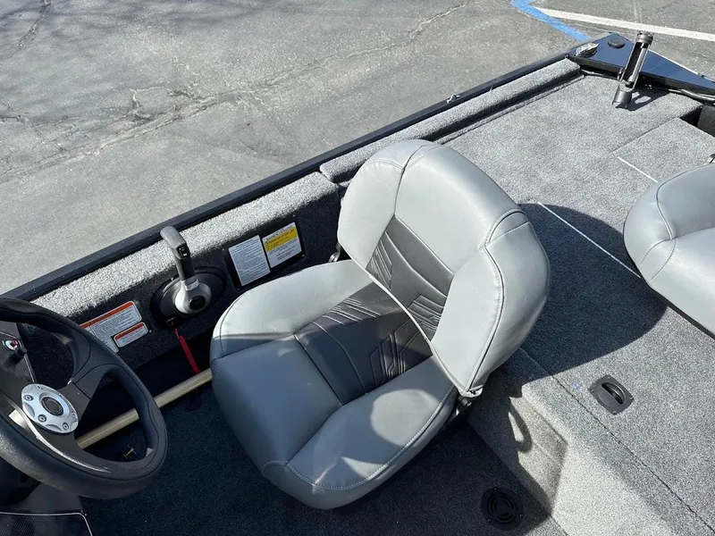 Slide: The Image of 2021 Tracker Bass Tracker Classic XL boat interior with gray seating and steering wheel. - 13