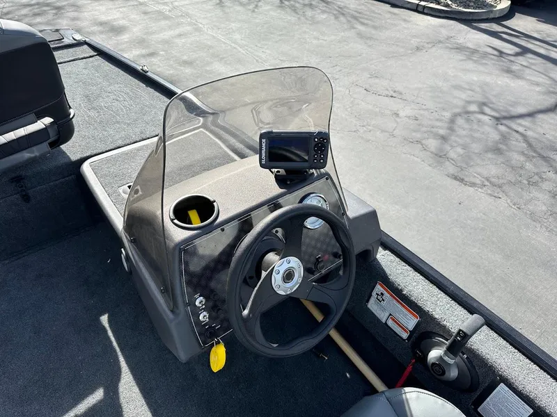 Slide: The Image of 2021 Tracker Bass Tracker Classic XL boat dashboard with steering wheel and navigation system. - 14