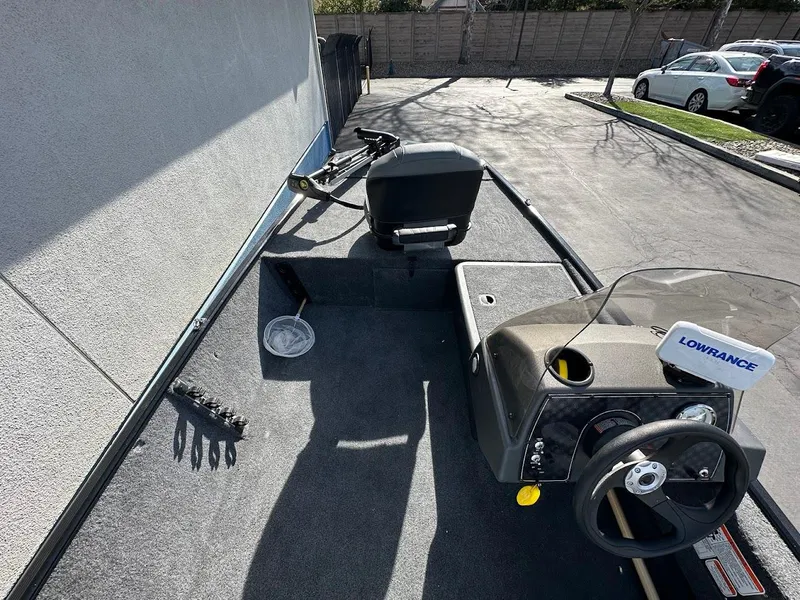 Slide: The Image of 2021 Tracker Bass Tracker Classic XL boat interior with steering wheel and Lowrance device. - 16