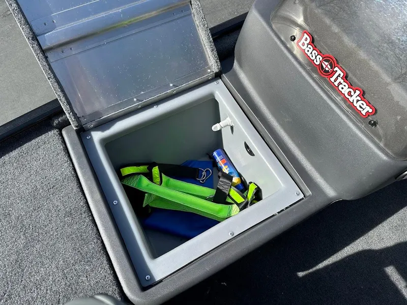 Slide: The Image of 2021 Tracker Bass Tracker Classic XL storage compartment with life jacket and spray can. - 19
