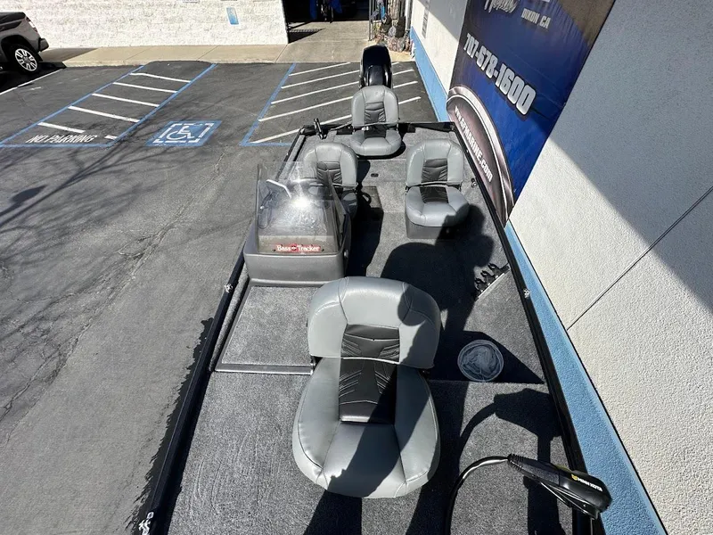 Slide: The Image of 2021 Tracker Bass Tracker Classic XL boat with gray seating, parked in a lot. - 22