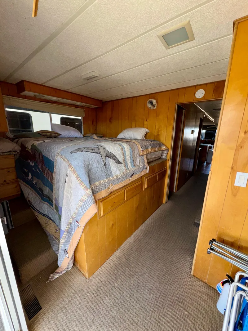 Slide: The Image of Cozy bedroom in 1993 Lakeview Full Ownership houseboat with wooden interior and twin beds. - 14