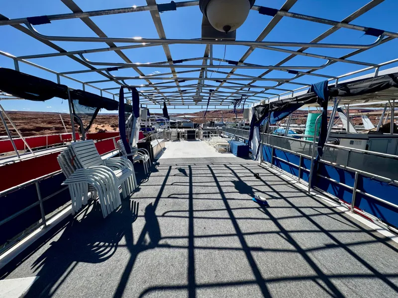 Slide: The Image of Upper deck of a 1993 Lakeview Full Ownership boat with chairs and open framework. - 18