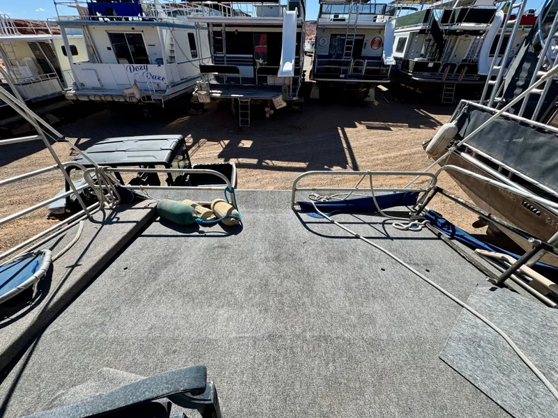 Slide: The Image of Rear deck view of a 1993 Lakeview Full Ownership houseboat in a marina. - 19