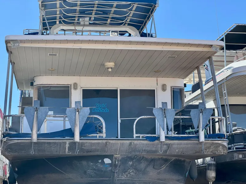 Slide: The Image of 1993 Lakeview Full Ownership houseboat with upper deck, docked under clear blue sky. - 21