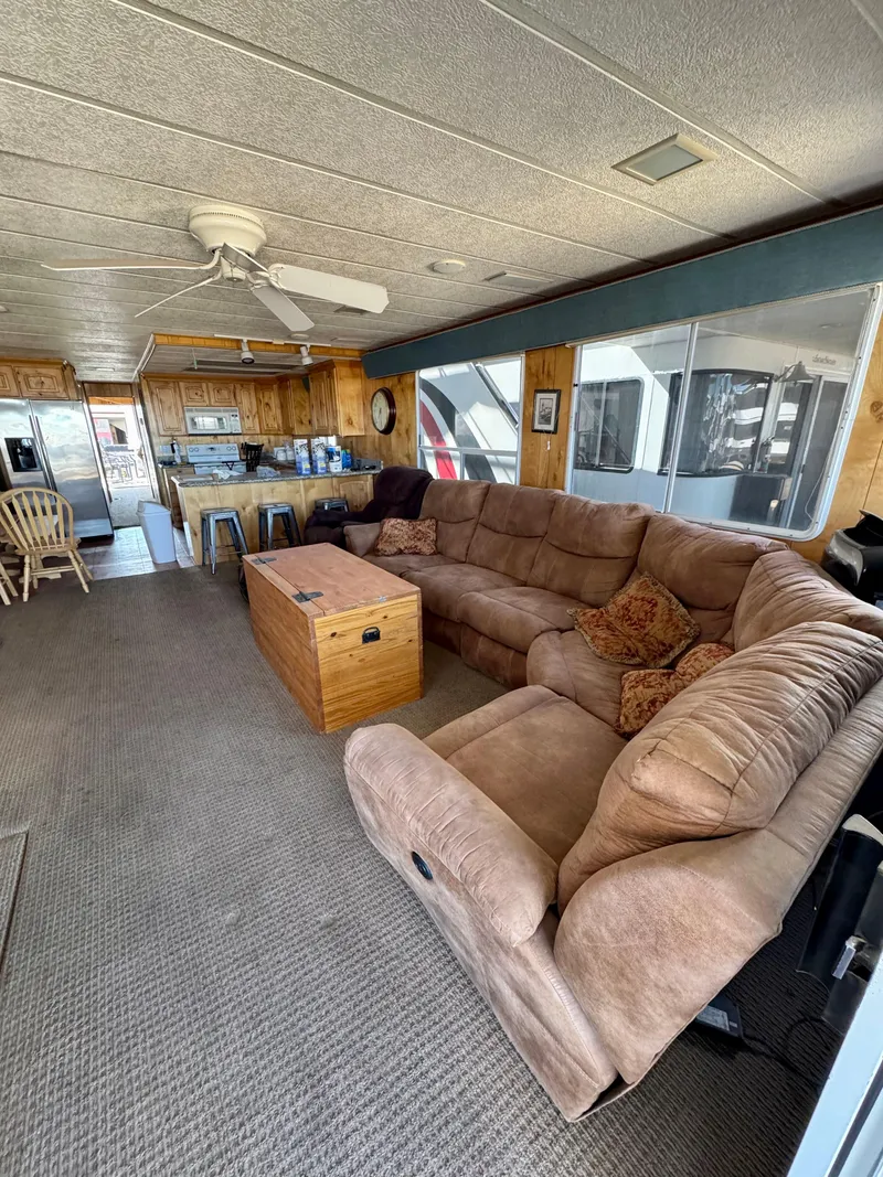 Slide: The Image of Spacious 1993 Lakeview houseboat interior with cozy seating and kitchen area. - 3