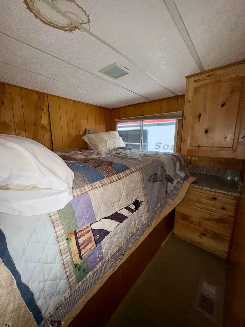 Slide: The Image of Cozy bedroom in 1993 Lakeview Full Ownership model with wooden walls and quilted bedding. - 8