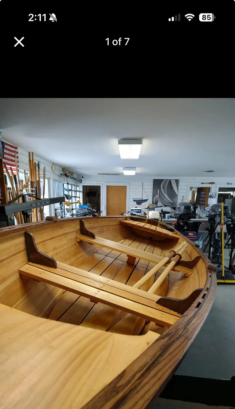 Slide: The Image of Custom 2016 cedar strip boat in workshop, showcasing wooden craftsmanship and interior details. - 2