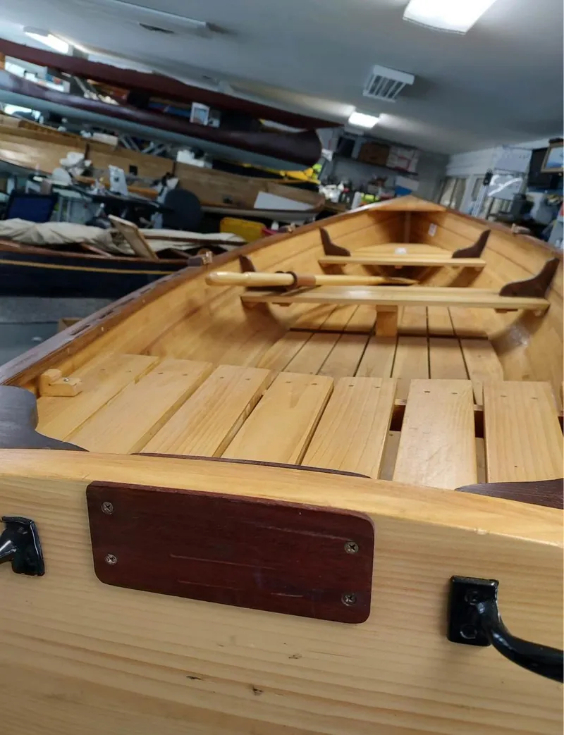 Slide: The Image of Custom 2016 cedar strip boat interior with wooden seats and oars in workshop setting. - 6