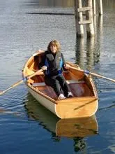 Slide: The Image of Person rowing a 2016 Custom Cedar Strip boat on calm water. - 7