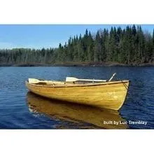 Slide: The Image of Custom Cedar Strip boat on a serene lake, surrounded by forest, 2016 model. - 9