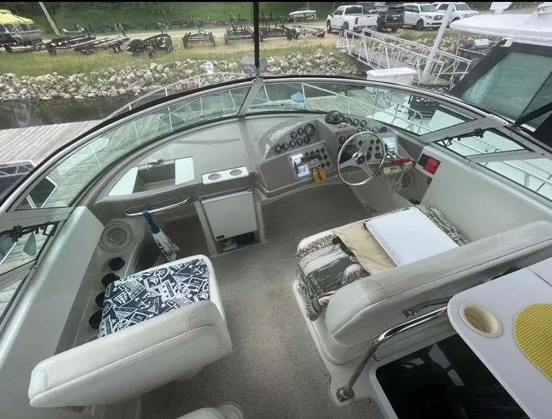 Slide: The Image of 1997 Carver 350 Mariner cockpit with steering wheel, gauges, and seating area. - 15