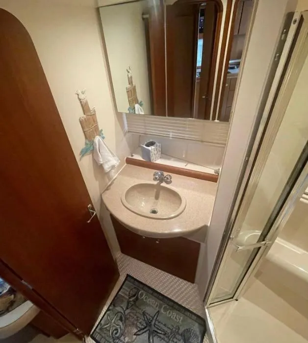 Slide: The Image of Bathroom interior of a 1997 Carver 350 Mariner yacht, featuring a sink and mirror. - 28