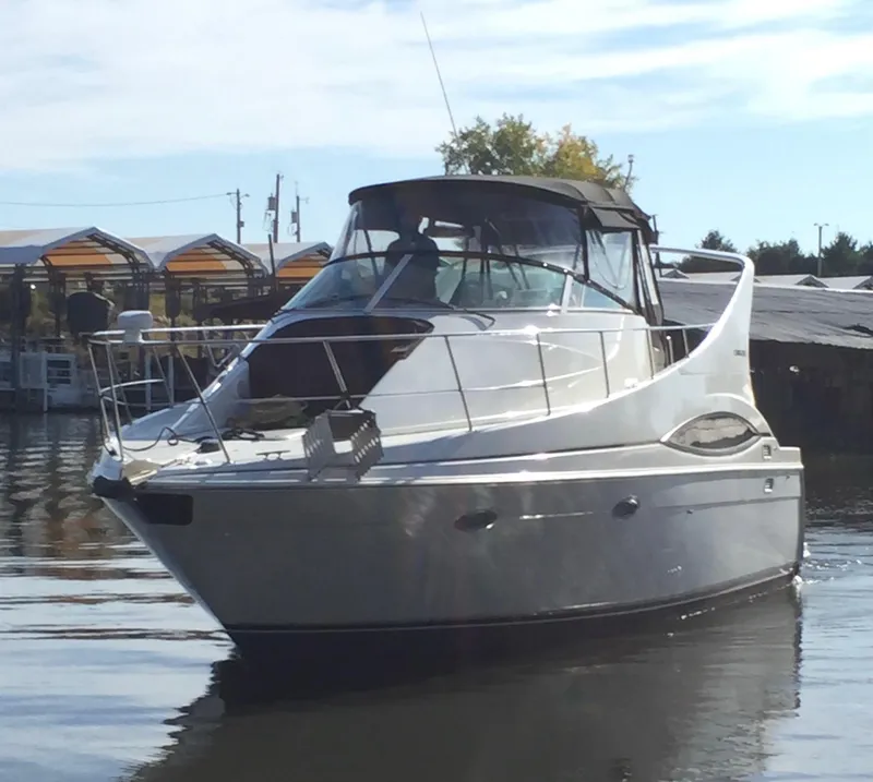 Slide: The Image of 1997 Carver 350 Mariner yacht docked on calm water. - 7