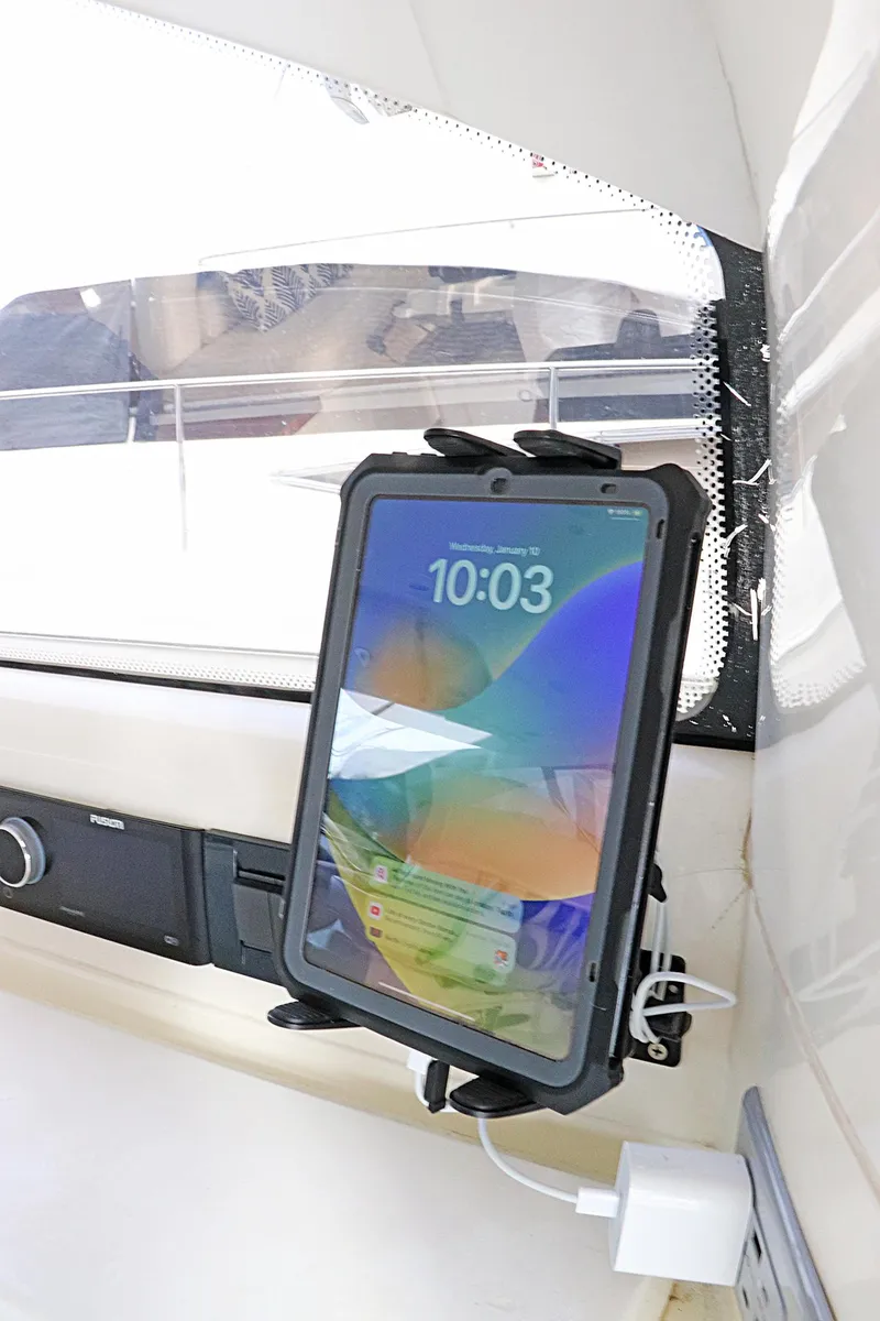 Slide: The Image of Bow of 2000 Sunseeker Predator 74 yacht with American flag, anchored on calm water. - 11