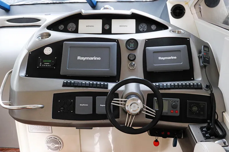 Slide: The Image of Luxury Sunseeker Predator 74 yacht helm seats, 2000 model, with sleek white design. - 17