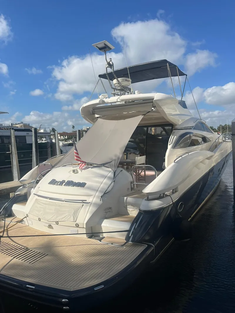 Slide: The Image of Sunseeker Predator 74 yacht docked, showcasing sleek design and luxury features, 2000 model. - 2