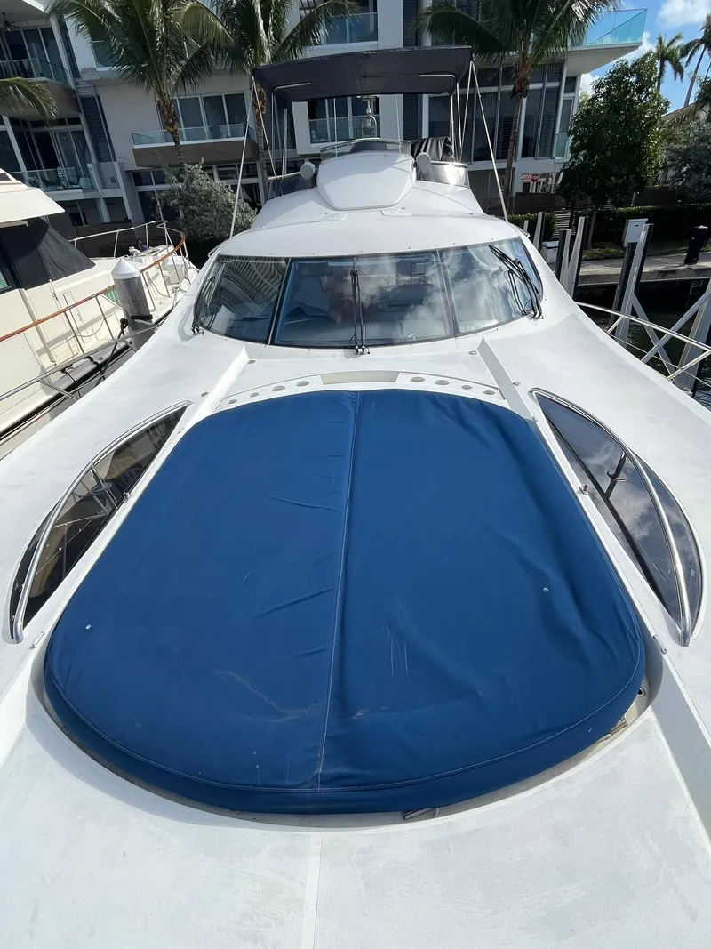 Slide: The Image of Sunseeker Predator 74 yacht docked at marina, rear view, clear sky. - 4