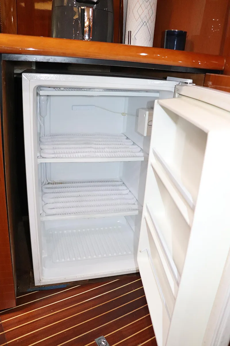 Slide: The Image of Luxurious kitchen interior of 2000 Sunseeker Predator 74 yacht with wooden cabinetry. - 43