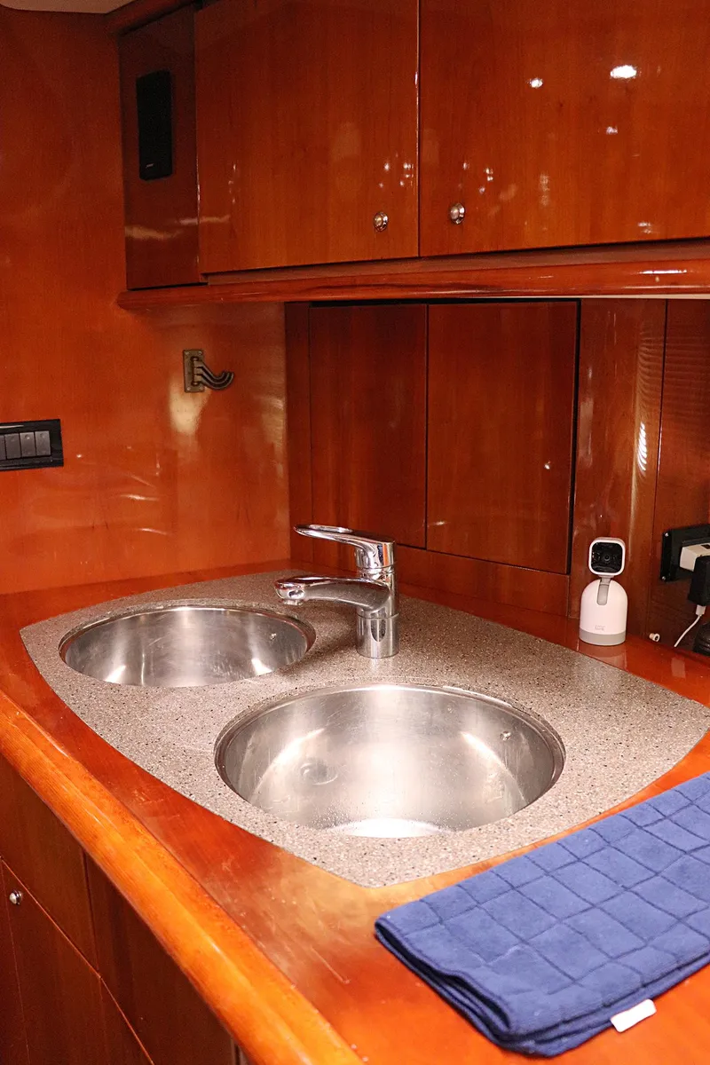 Slide: The Image of Sunseeker Predator 74 yacht kitchen with wooden cabinets and compact appliances, 2000 model. - 45