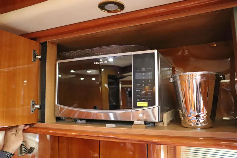 Slide: The Image of Interior of 2000 Sunseeker Predator 74 yacht with mounted TV and wooden cabinetry. - 55