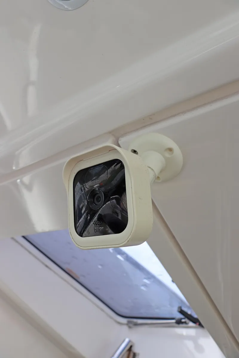 Slide: The Image of White security camera mounted on a ceiling corner inside a Sunseeker Predator 74 yacht. - 71
