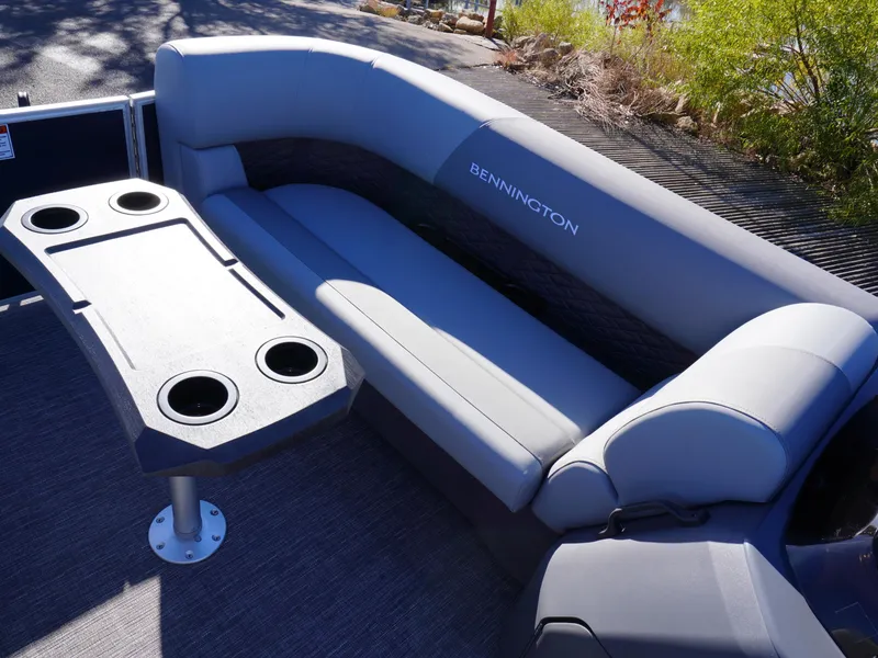 Slide: The Image of 2025 Bennington 20 SSB boat interior with gray seating and table with cup holders. - 14