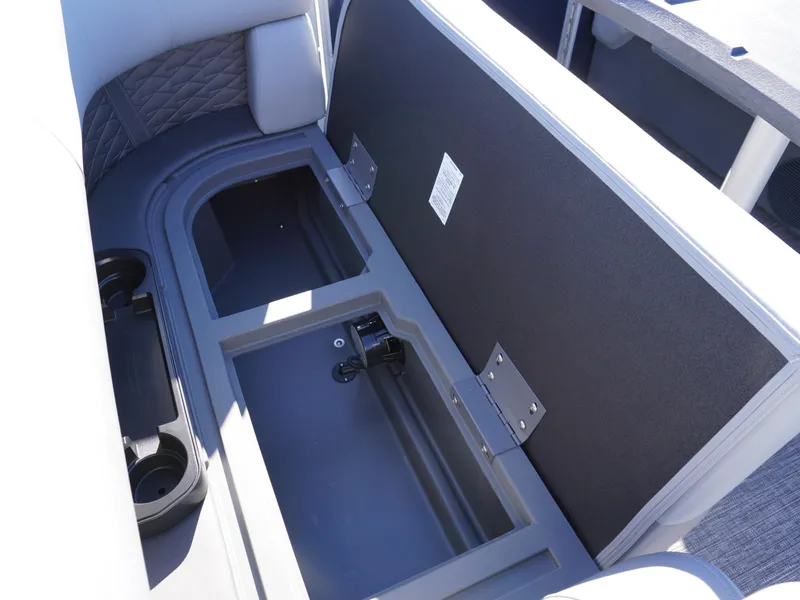 Slide: The Image of 2025 Bennington 20 SSB boat storage compartment with cup holders and cushioned seating. - 17