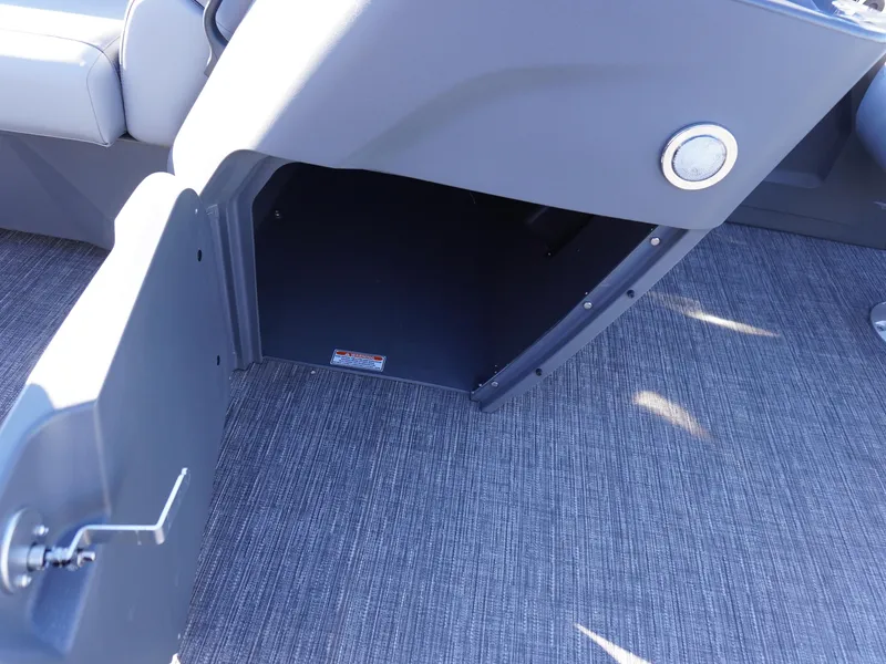 Slide: The Image of 2025 Bennington 20 SSB boat storage compartment with open door, gray interior. - 18