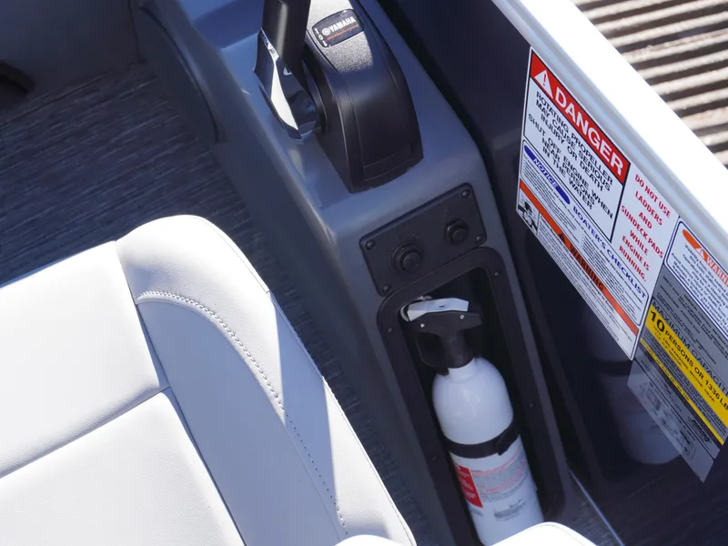 Slide: The Image of 2025 Bennington 20 SSB boat interior with safety labels and fire extinguisher. - 20