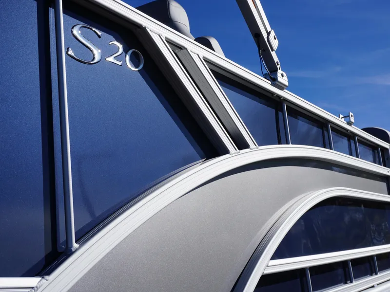 Slide: The Image of 2025 Bennington 20 SSB pontoon boat with sleek blue and silver design. - 22