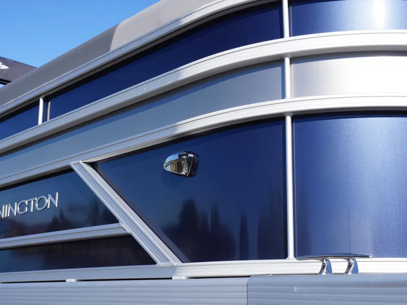 Slide: The Image of 2025 Bennington 20 SSB boat, sleek blue and silver exterior design. - 23